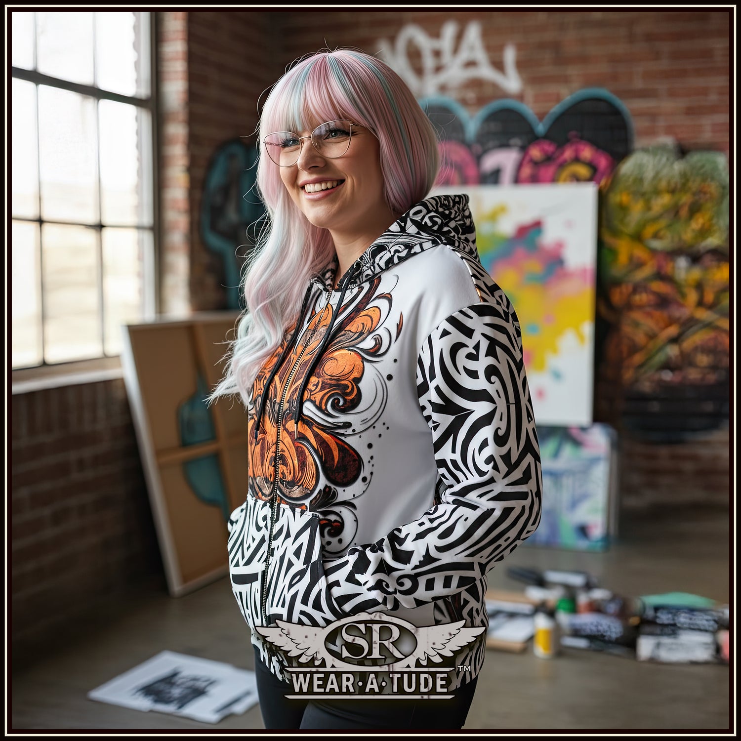 Woman with cotton candy colored hair in an art studio, wearing a Bold black and white print hinting at a Chicano style with an abstract rust orange chest print 