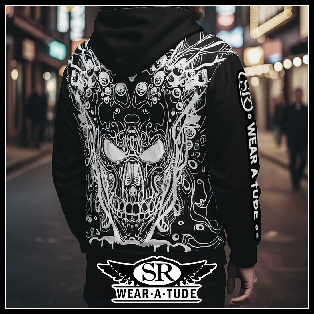 Back of a black metal hoodie with white skull circuitry design and SR WearAtude sleeve print on a night street background.